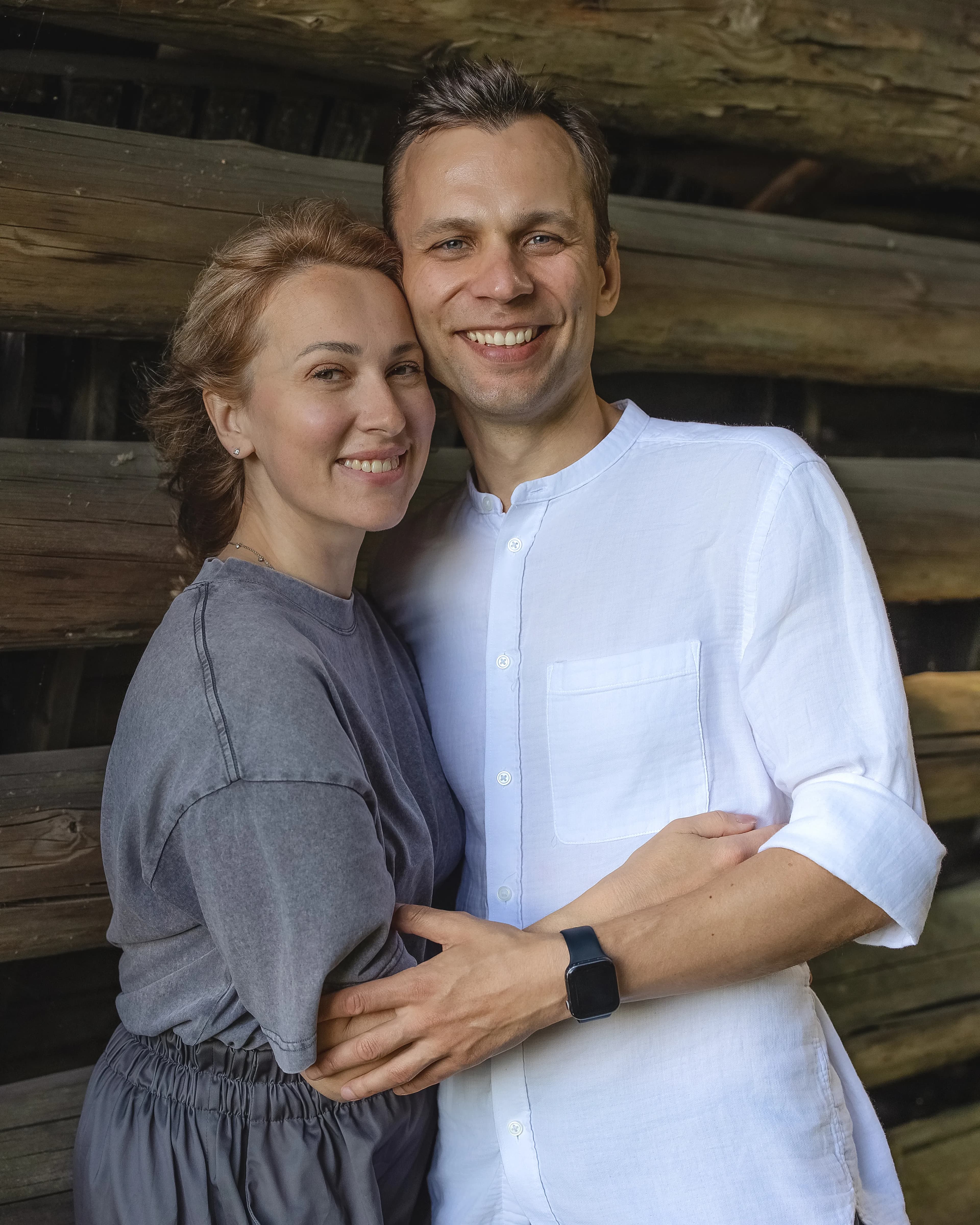 Beautiful outdoor portrait of a family by log cabin