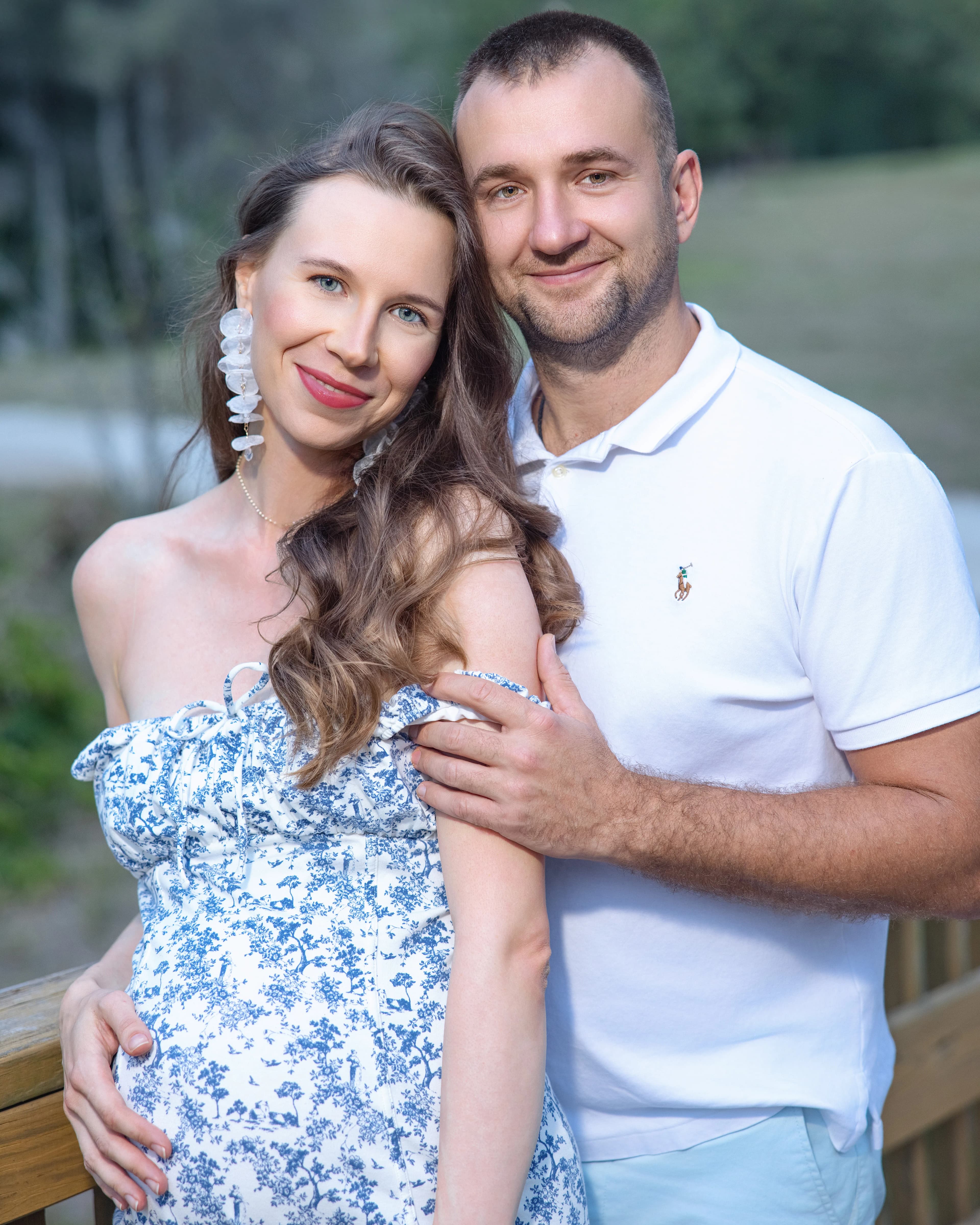Maternity couple portrait on wooden bridge