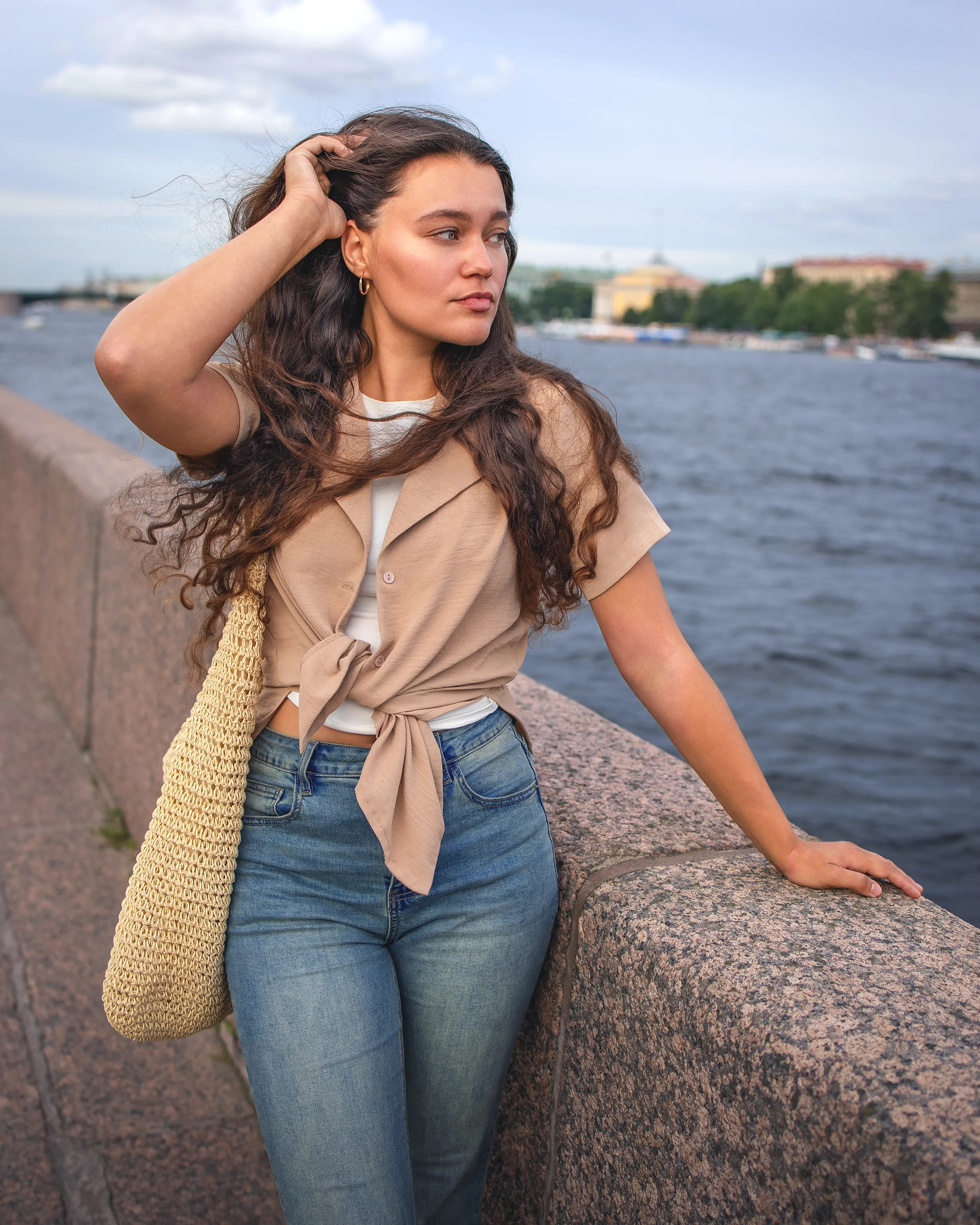 City river portrait of a young woman with curly hair