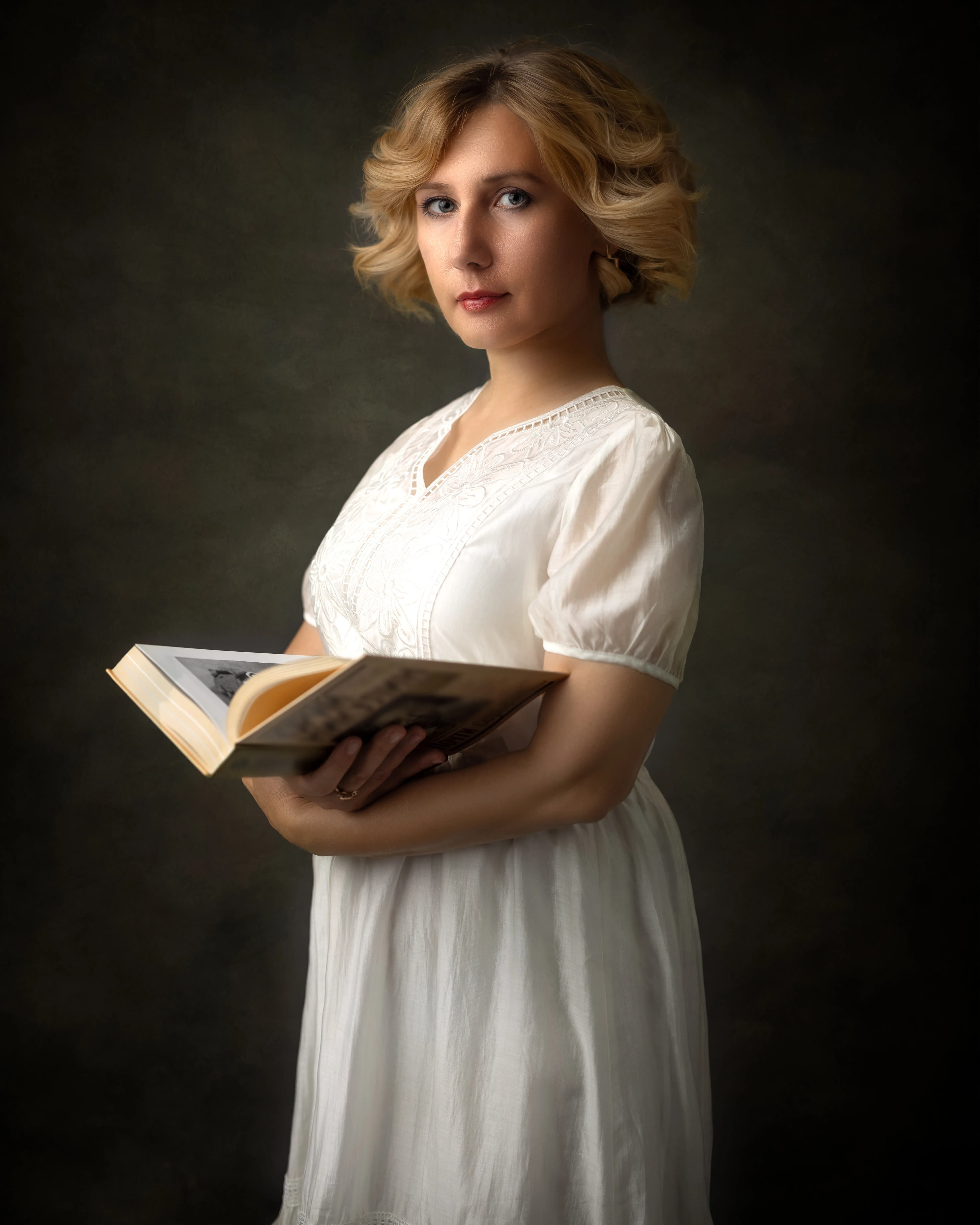 Fine art portrait woman white dress holding book