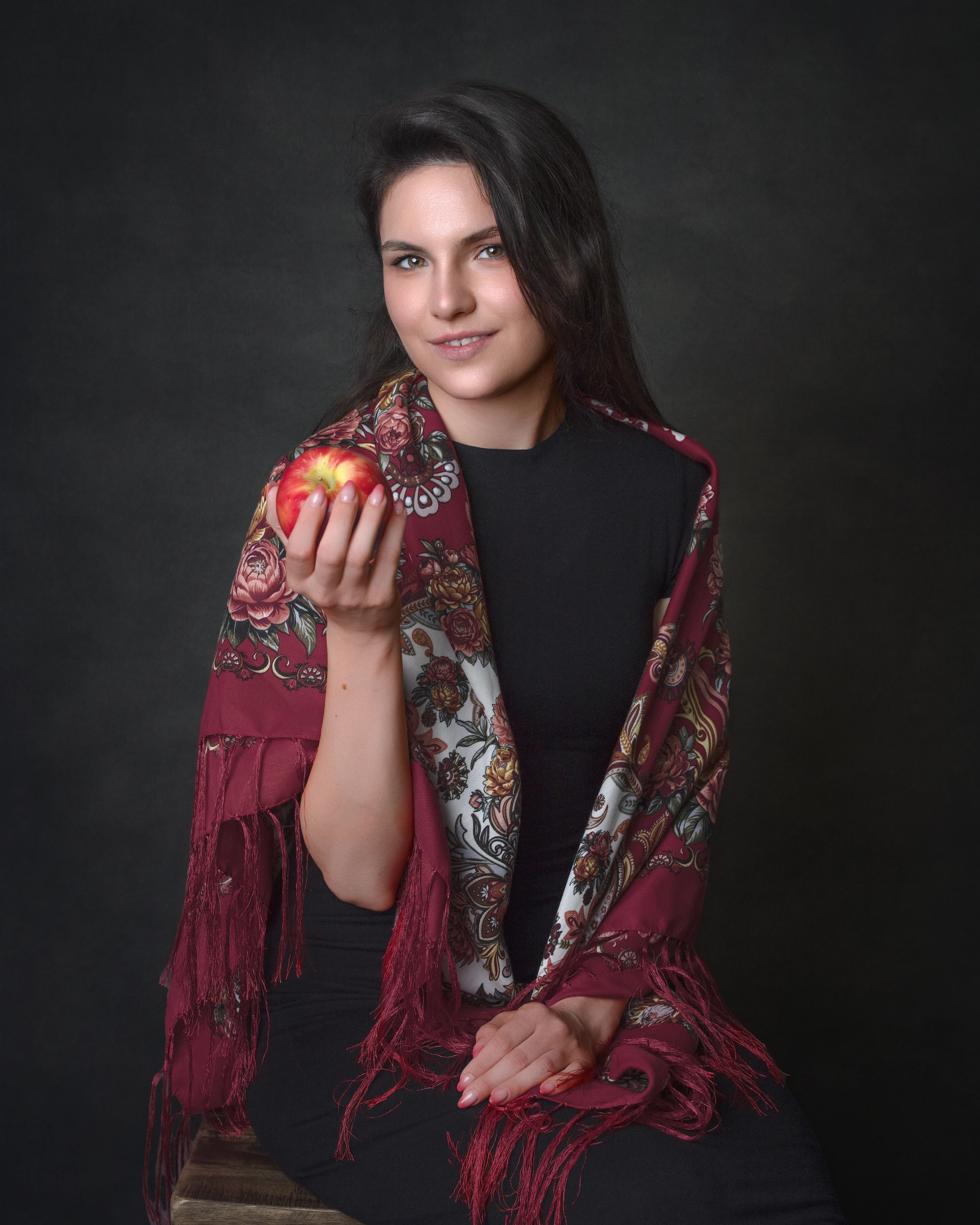 Fine art portrait woman red shawl holding apple