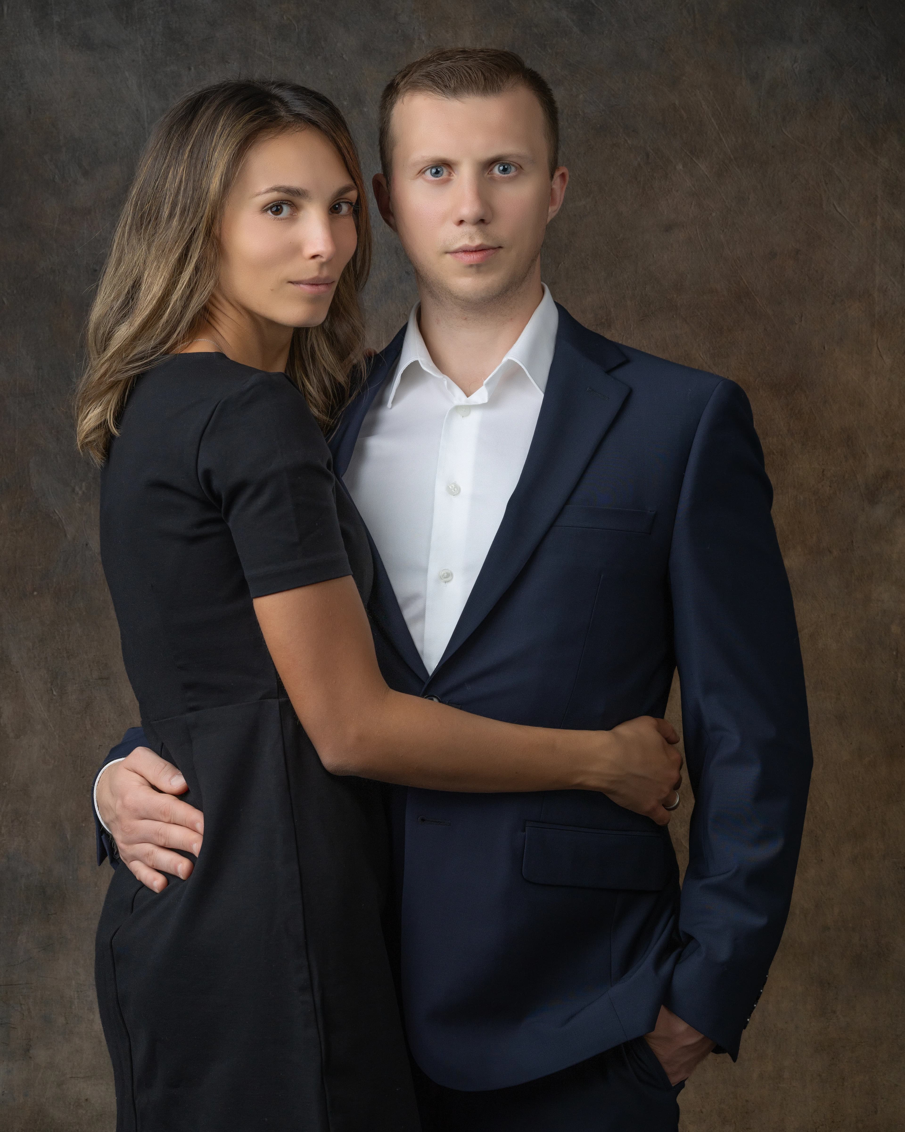 Studio couple portrait man suit woman black dress